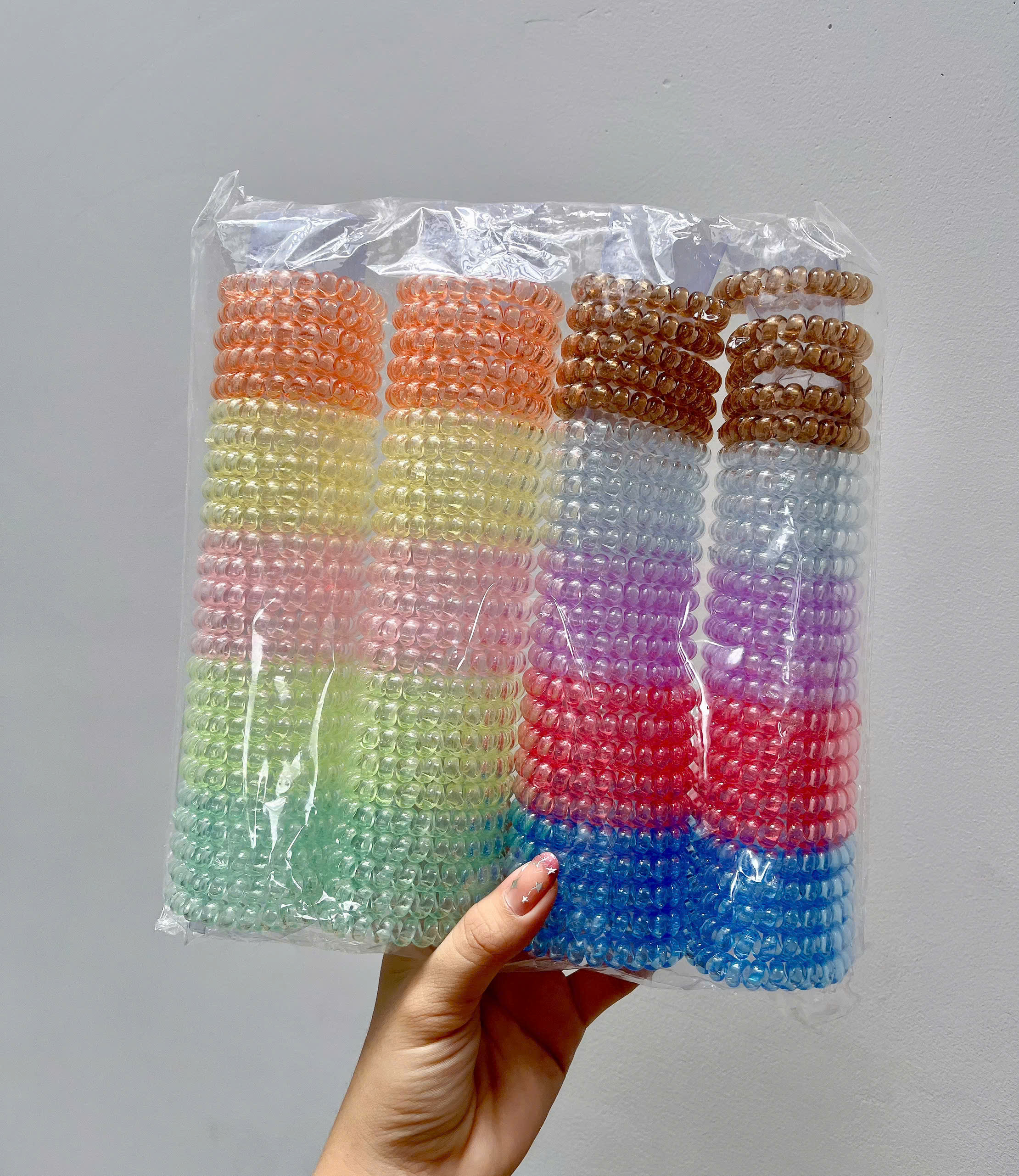 Túi 100 dây buộc tóc lò xo co giãn, bằng nhựa dẻo