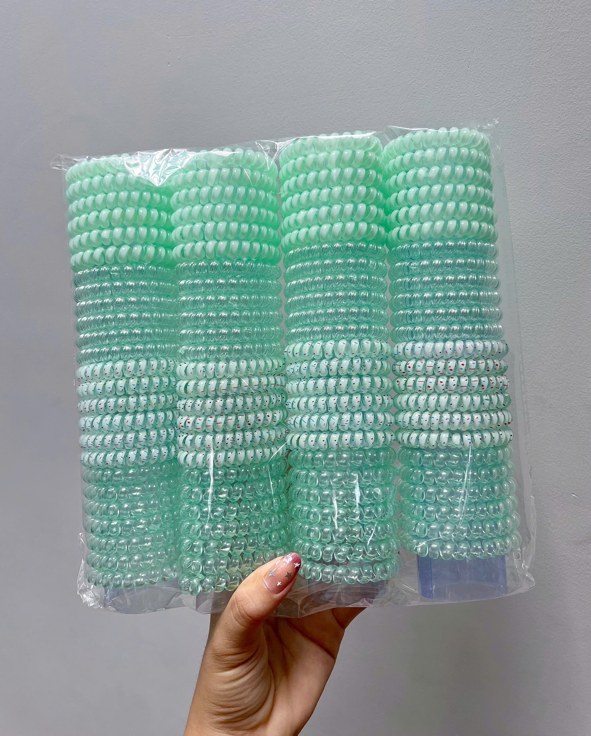 Túi 100 dây buộc tóc lò xo co giãn màu trong suốt, bằng nhựa dẻo